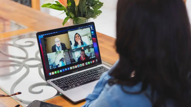 Parenting and relationship coach Yolanda Alvares smiling during a virtual group coaching session on Zoom, engaging with participants from diverse backgrounds in a supportive, online environment.