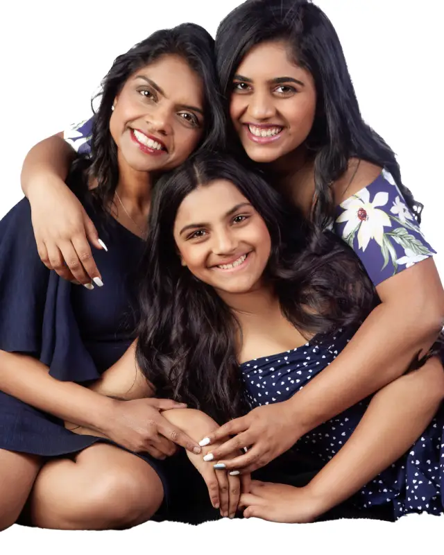 mom and 2 daughters hugging and posing for picture